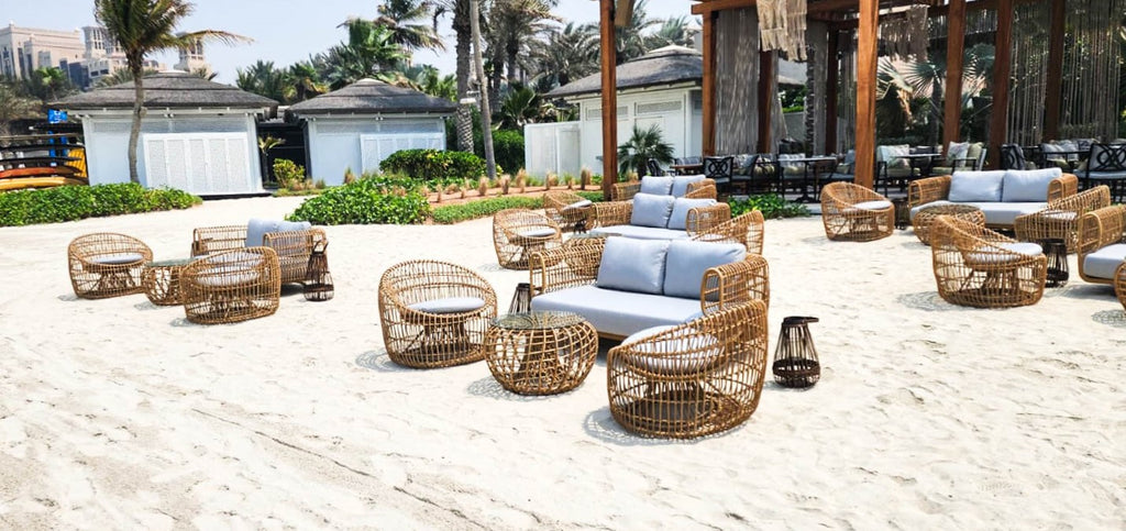 Beach lounge at French Riviera Beach furnished with Nest lounge furniture - 2-seater sofa, round coffee table and round lounge chairs