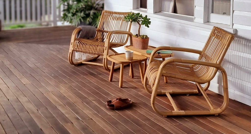 Verandah decor with two natural Cane-line Curve lounge chairs with a set of teak side tables from Cane-line Royal series 