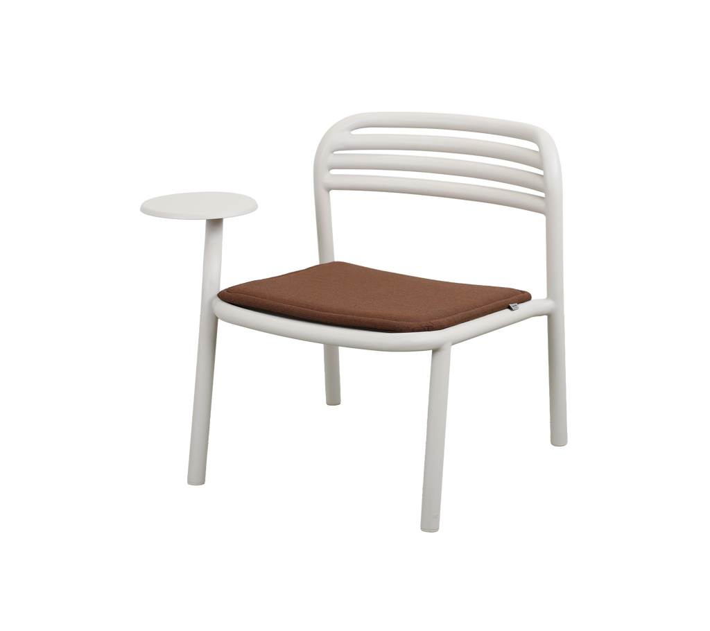 Modern white chair with a brown cushion and a side table.