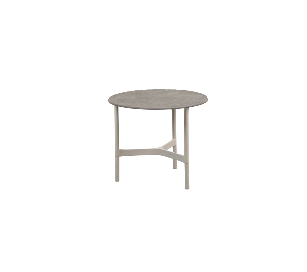 Round table in a neutral color with a simple design.