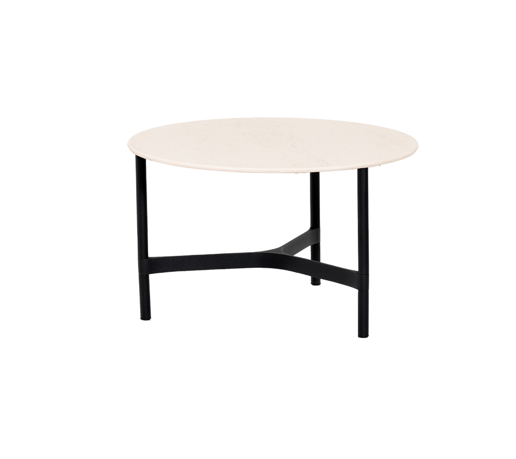 Round table with a light-colored top and a sturdy black frame, ideal for versatile placement in various settings.