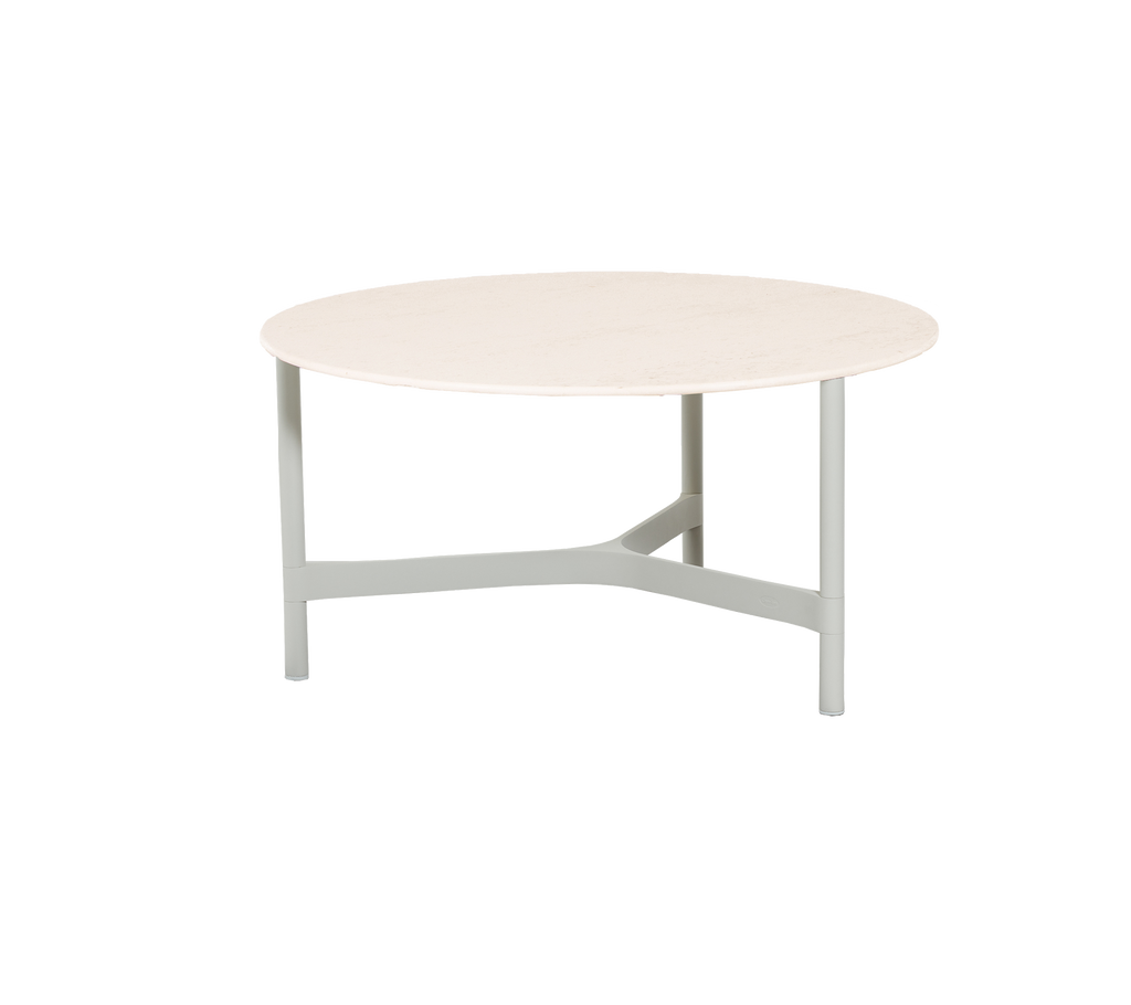 Round table with a light-colored top and a sturdy, minimalist grey base, suitable for various settings. 