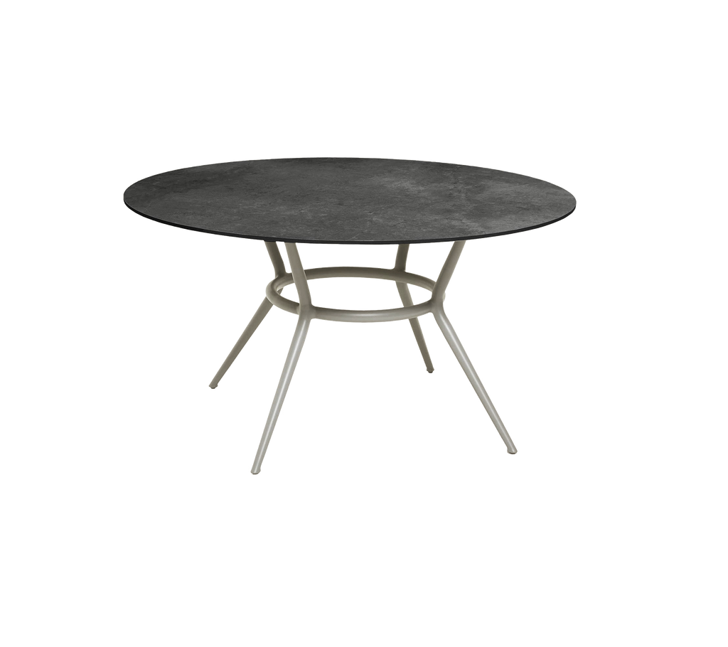 Round dark grey table with a minimalist design and light-colored legs.