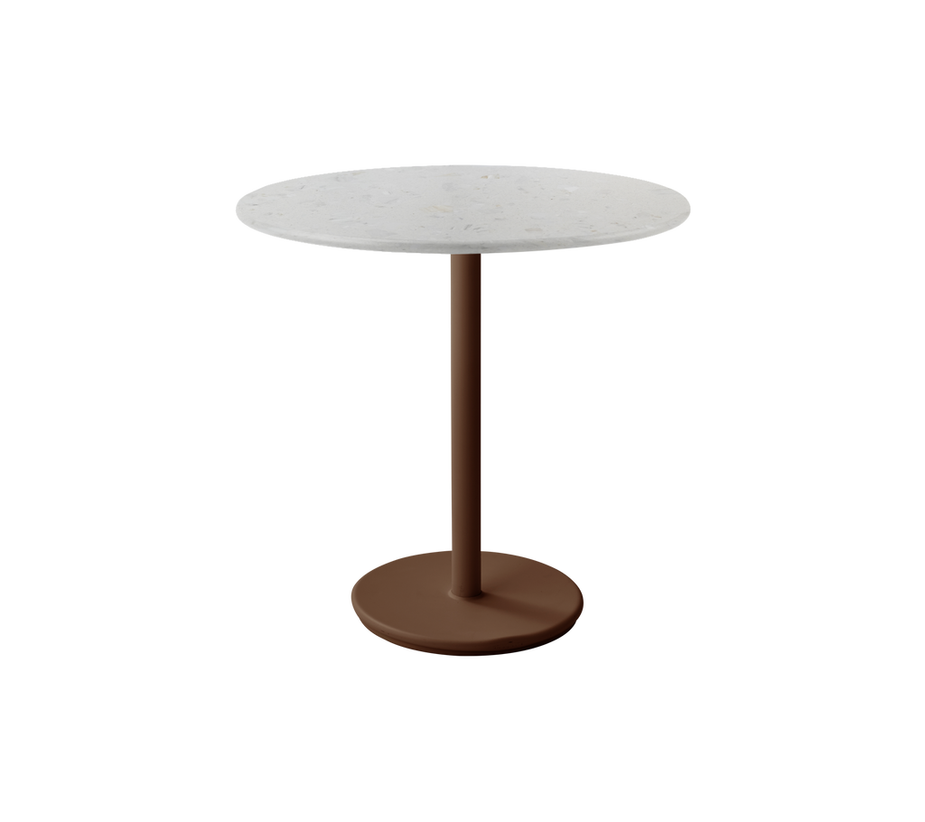 Modern round table with a white top and desert red base.