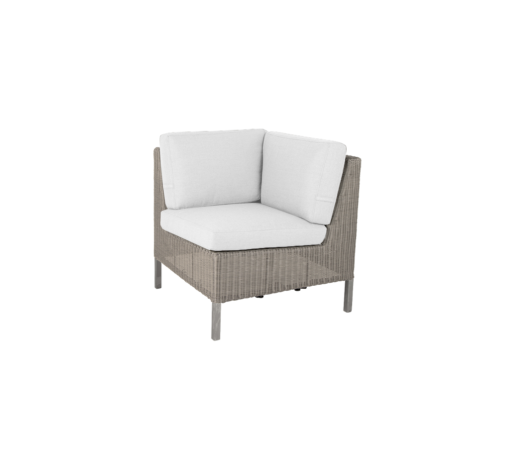 Corner chair with a woven exterior and plush white cushions, perfect for adding comfort and style to any space.