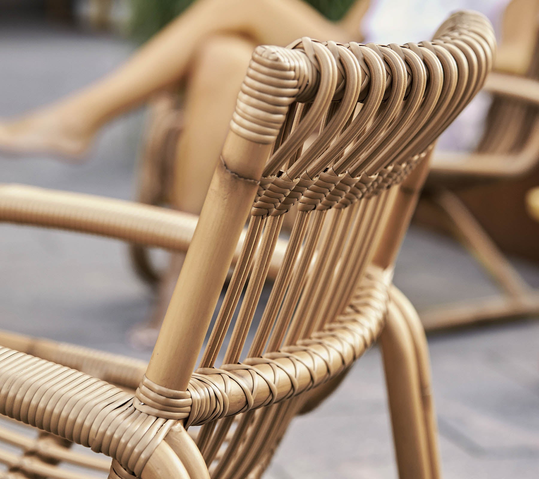 Close-up view of a stylish woven chair with a modern design, showcasing detailed craftsmanship and natural materials.