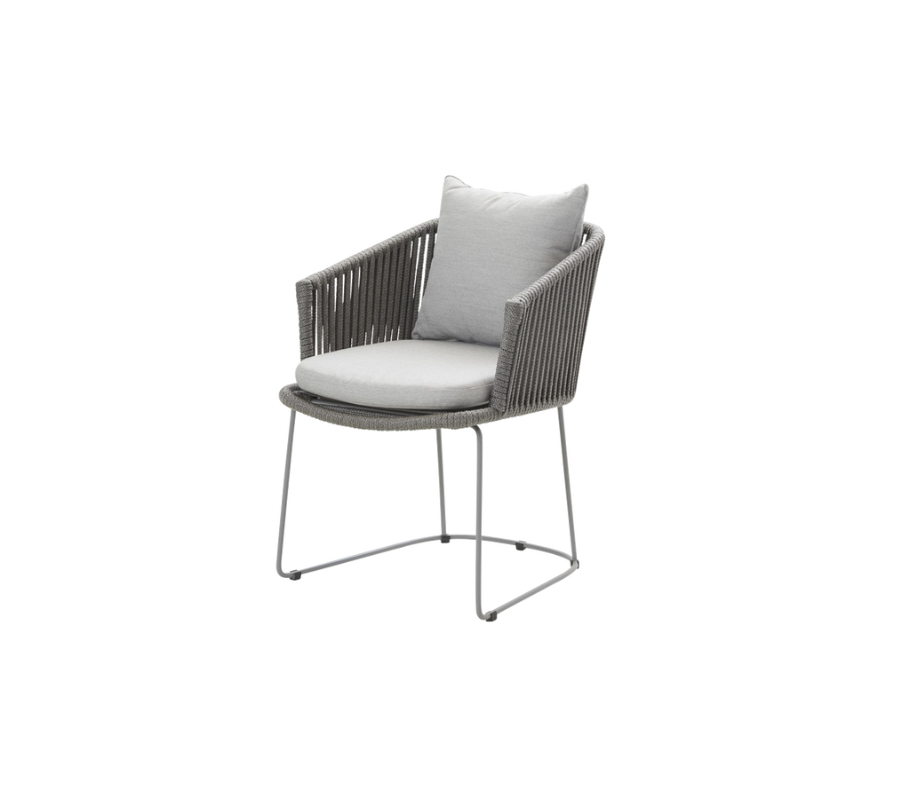 Modern chair with a grey woven design, round seat cushion, and a light grey back pillow, suitable for indoor or outdoor use.