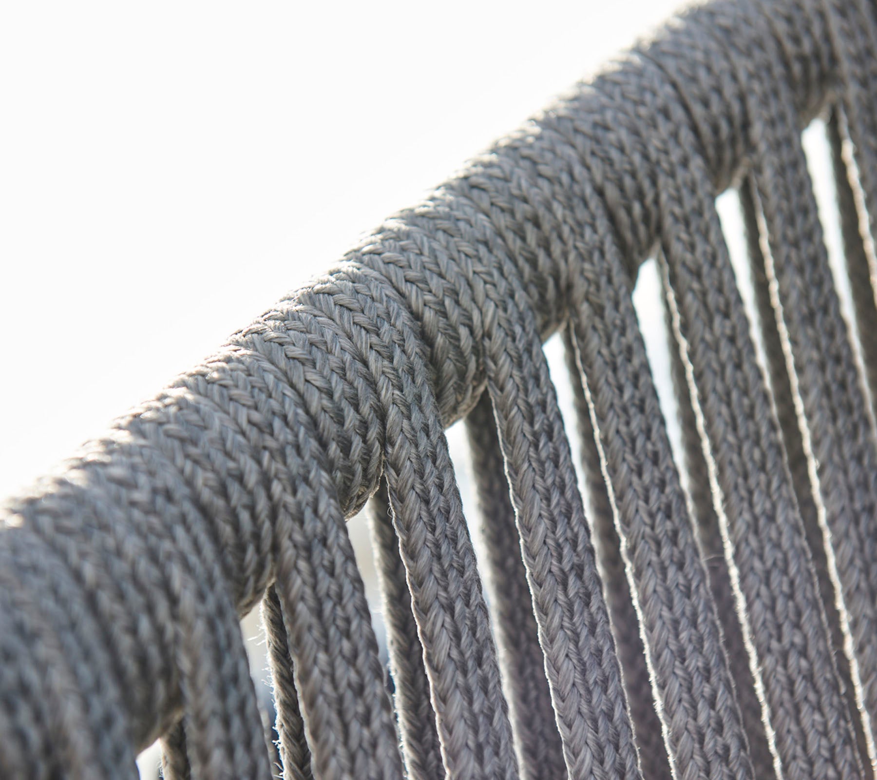 Close-up of gray rope detailing, highlighting the texture and pattern of a woven design.