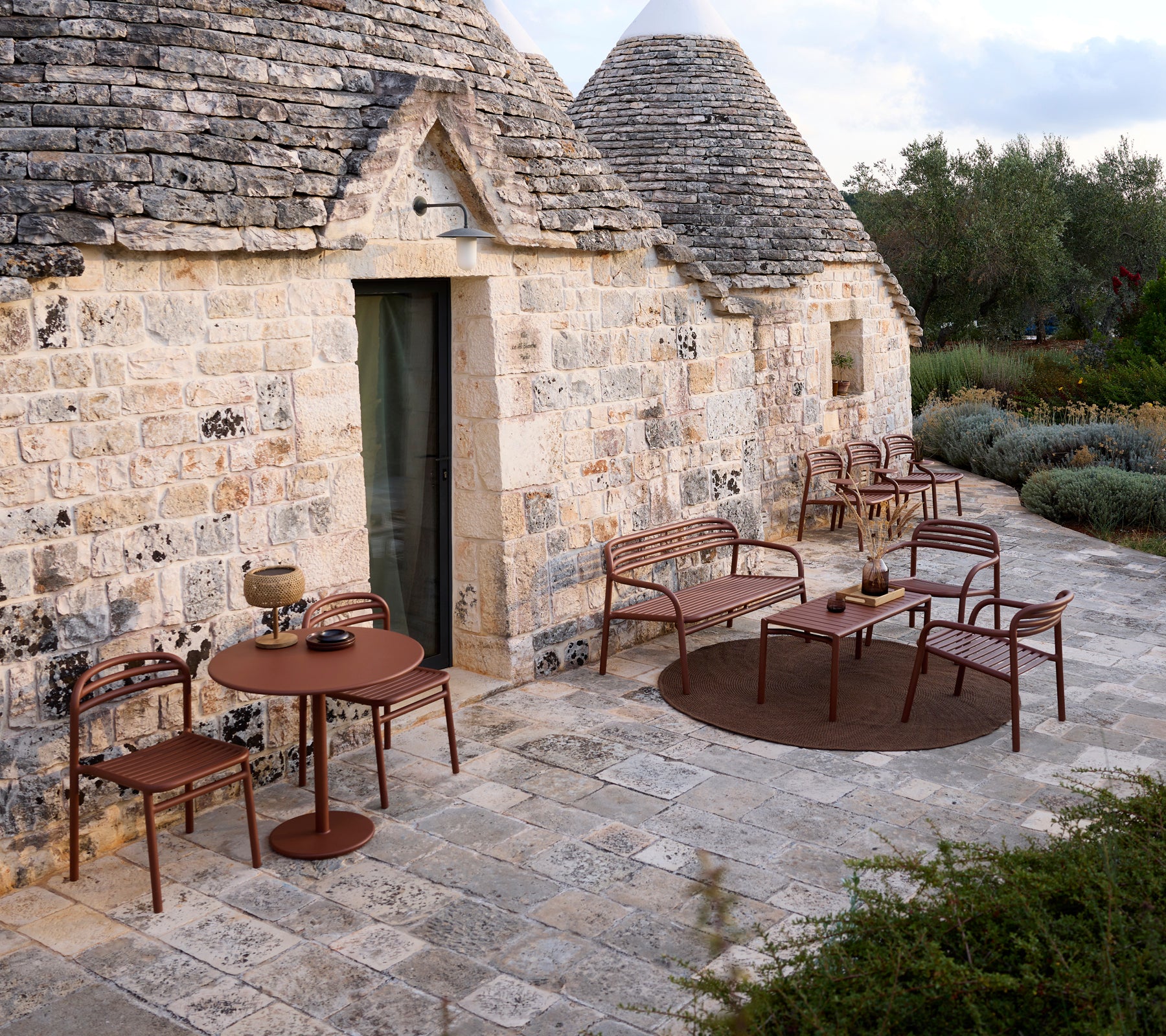 Outdoor setting with a brown table and chairs in a modern design.