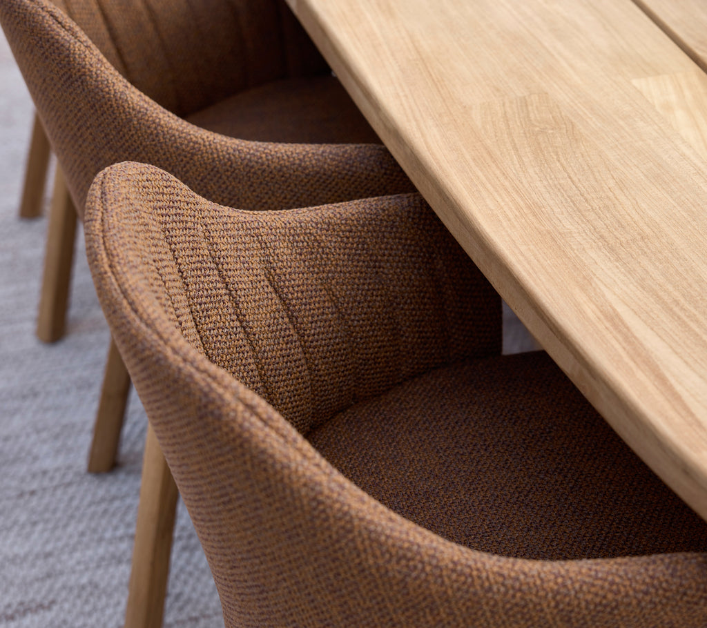 Brown dining chairs paired with a wooden table in a modern setting.