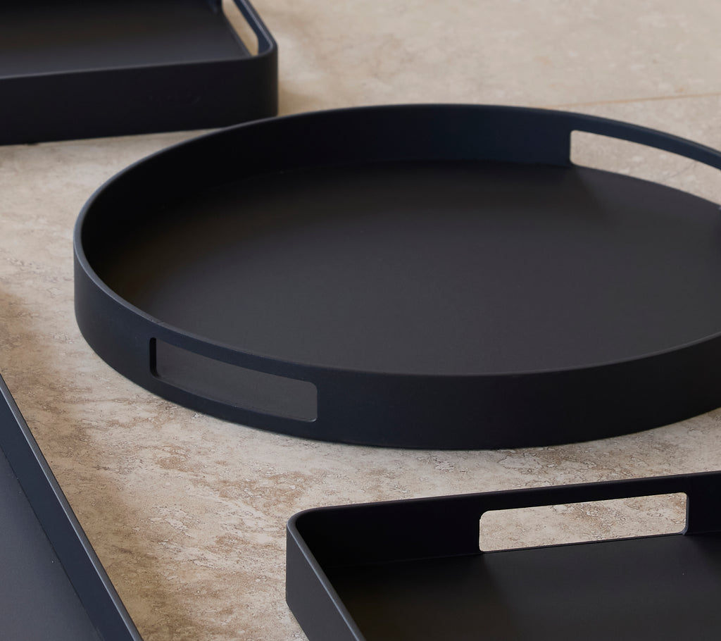 Lava grey club tray with a minimalist design, featuring handles for easy carrying, arranged among other trays.