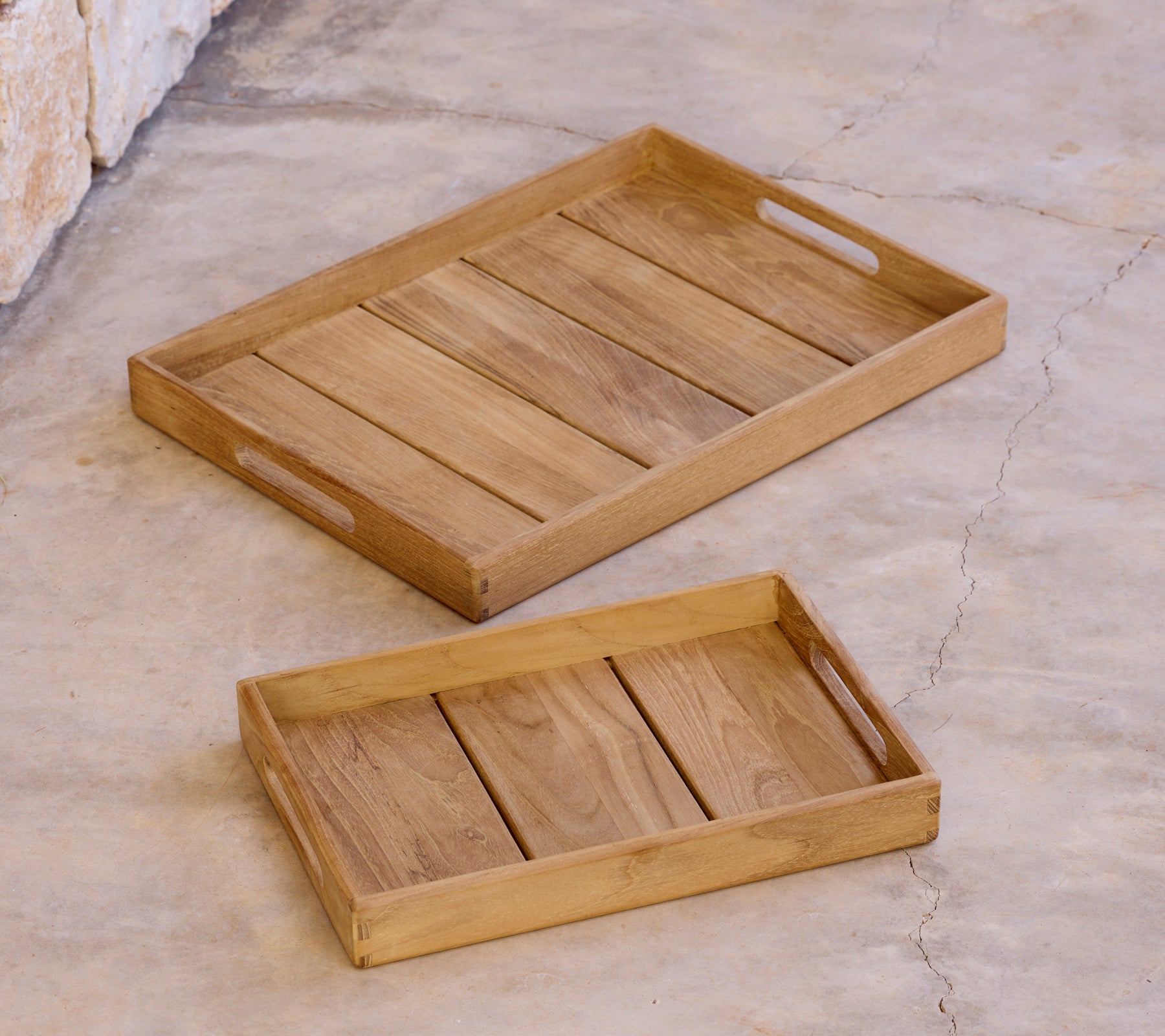Two wooden trays of different sizes arranged on a surface.