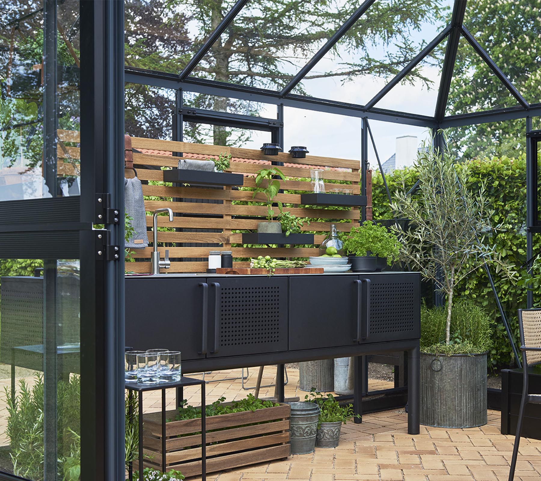 A modern storage unit with plants on wooden shelves, surrounded by greenery and arranged decoratively with various plant pots.
