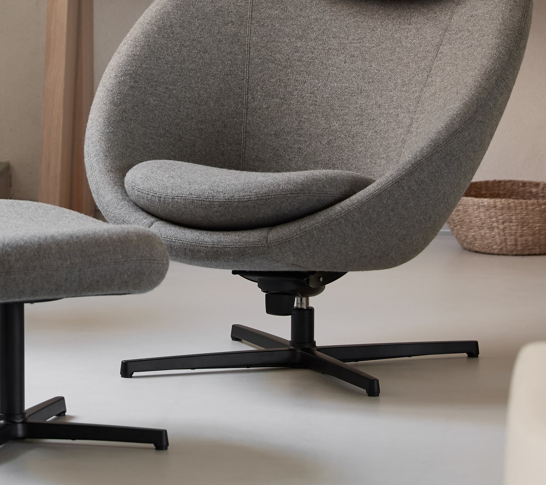 Modern grey lounge chair with a sleek design in a contemporary setting.