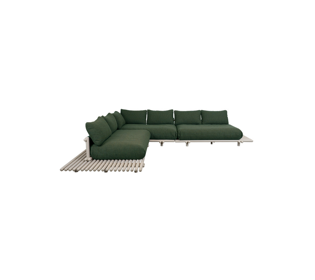 Modern dark green sofa in a contemporary lounge setting.