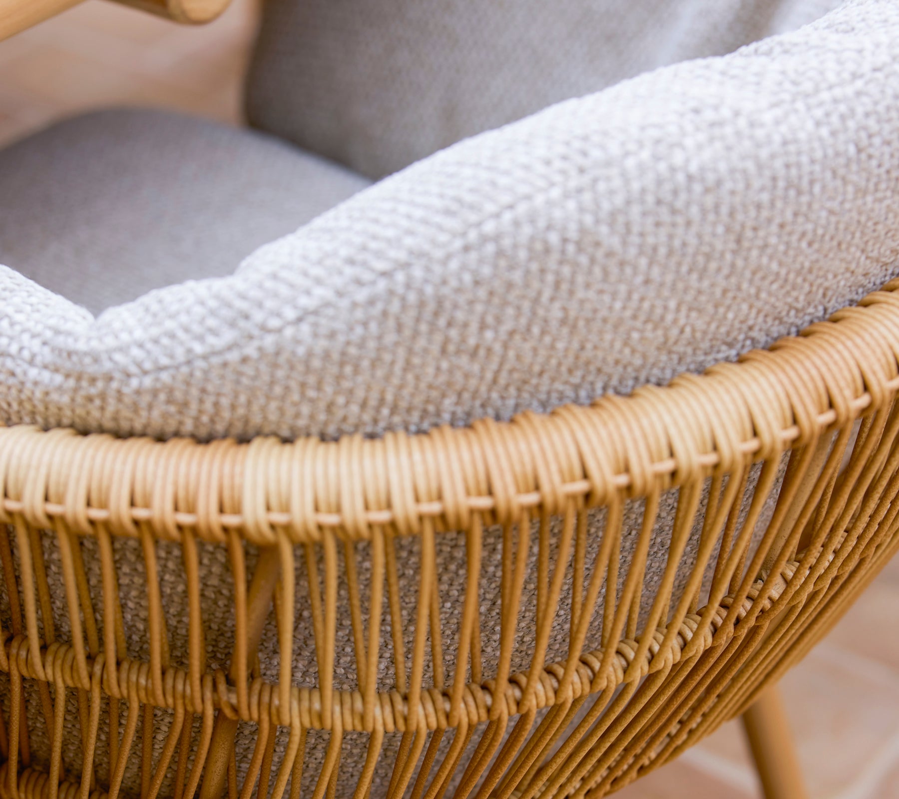 Stylish dining chair featuring a woven design with aluminum legs and a comfortable gray Rice cushion.