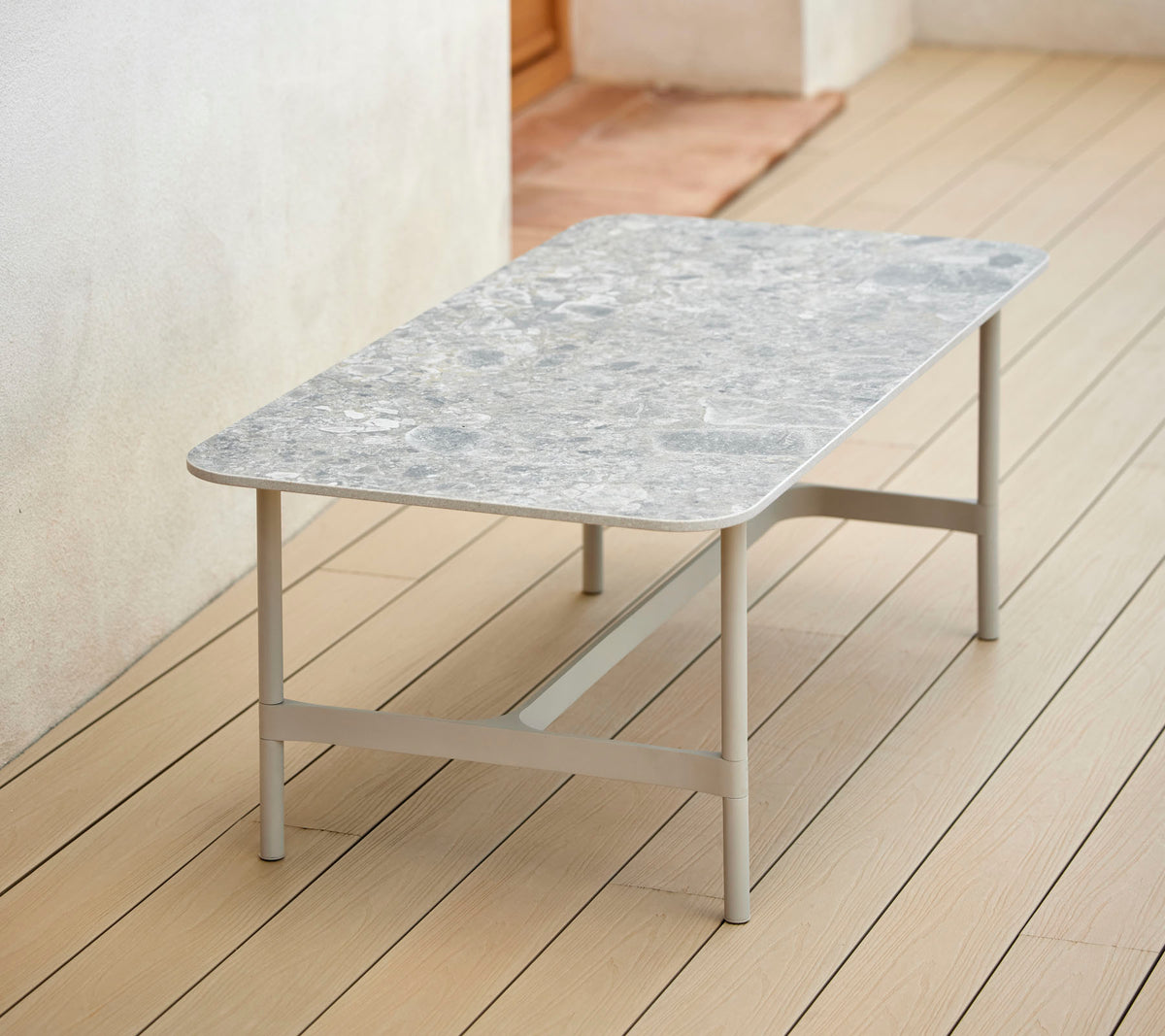 A stylish rectangular coffee table with a patterned top and sturdy metal legs, perfect for modern decor.